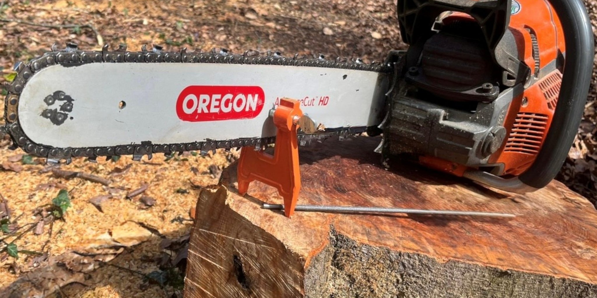Oregon chainsaw on a log with a blurred natural background