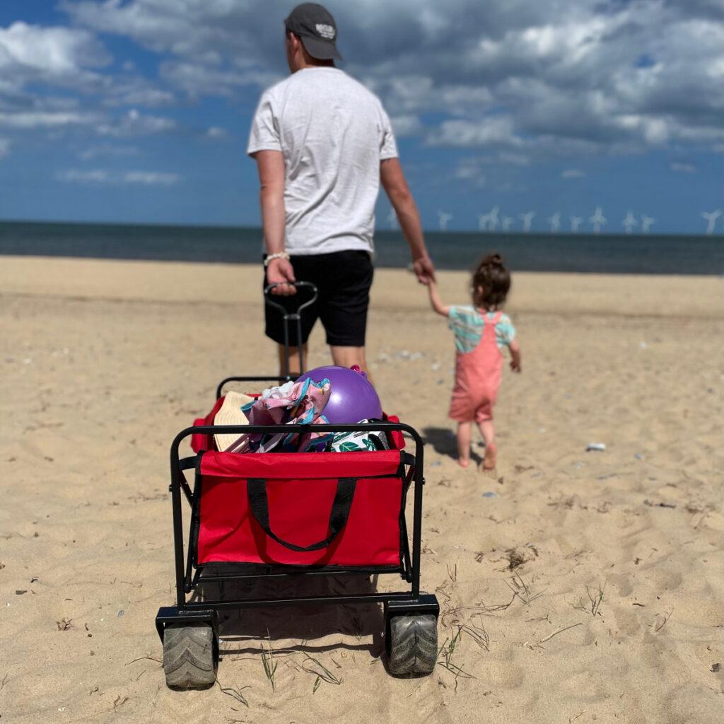 Man pulling Bull All Terrain Outdoor Wagon Trolley